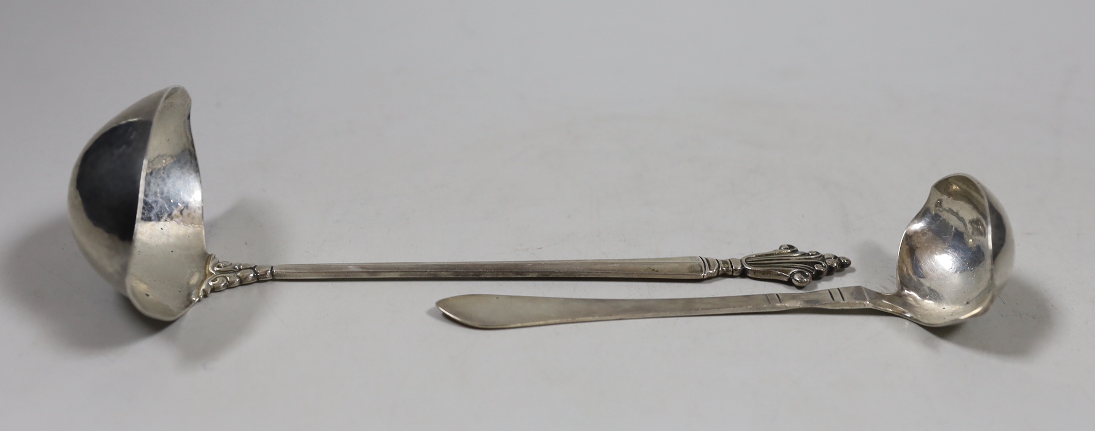 Two Georg Jenson sterling silver ladles, import marks for London, 1926, largest 19cm.